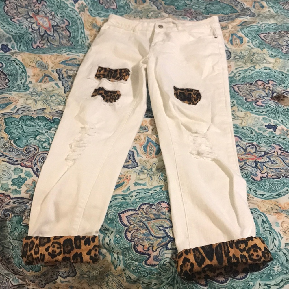 White distressed jeans with leopard details.